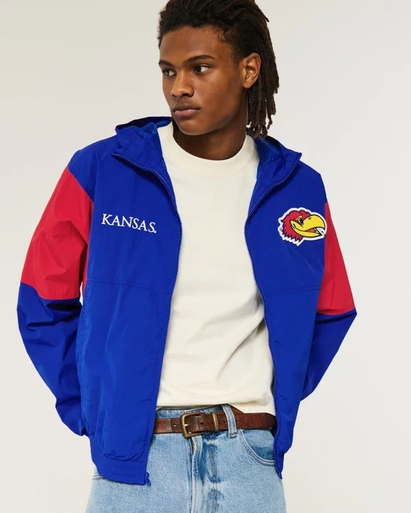 Windjacke mit Kapuze und Grafik der University of Kansas Jayhawks Windjacke mit Kapuze und Grafik der University of Kansas Jayhawks